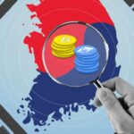 Map of South Korea with flag under magnified glass.