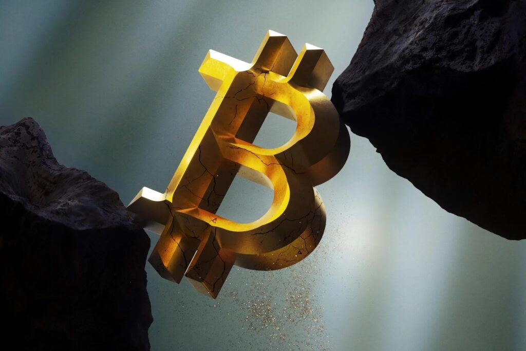 A large Bitcoin nestled between 2 x rocks.